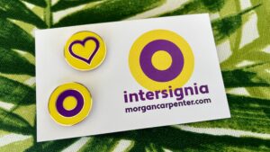 The two intersignia pins, attached to a card with the intersignia roundel logo